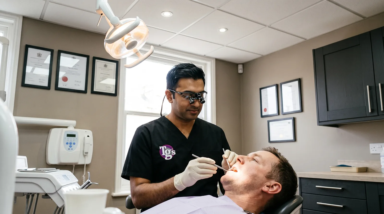 Dentist explaining root canal treatment to a patient using a model of a tooth