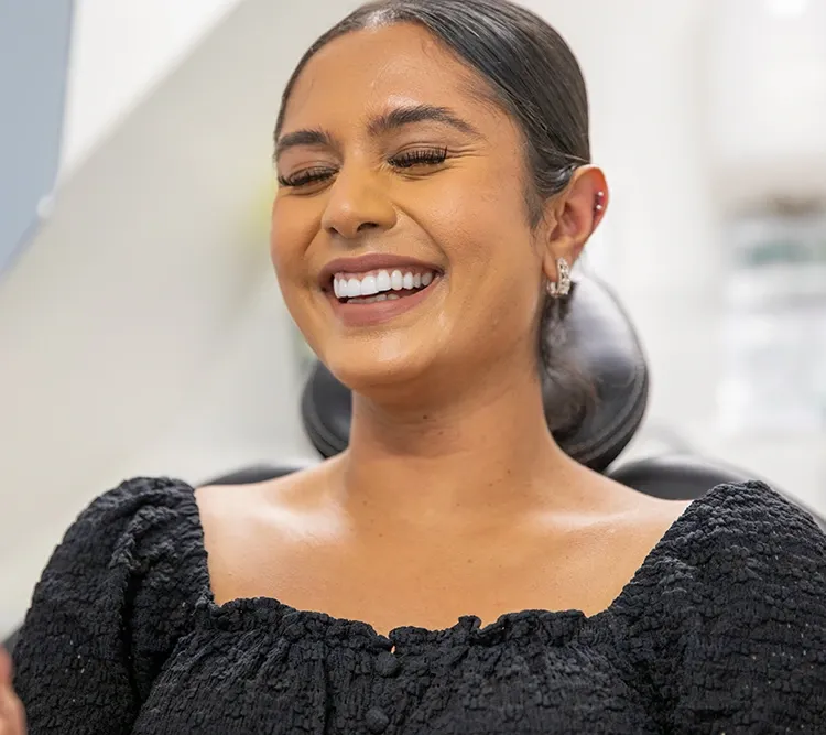 Close-up portrait of a patient smiling, showing a healthy, bright smile
